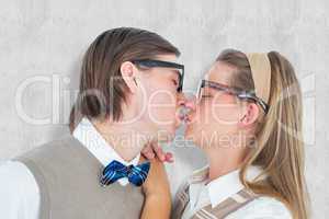 Composite image of geeky hipster couple kissing