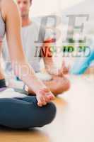 Composite image of cropped couple in meditation pose at fitness