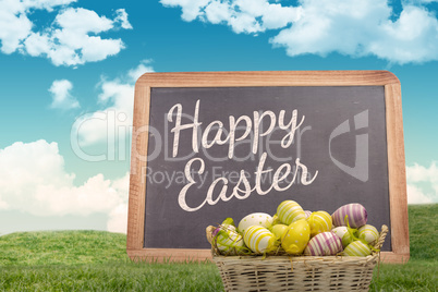 Composite image of easter eggs in basket