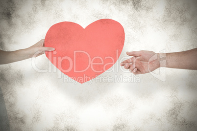 Composite image of woman giving heart card to her boyfriend