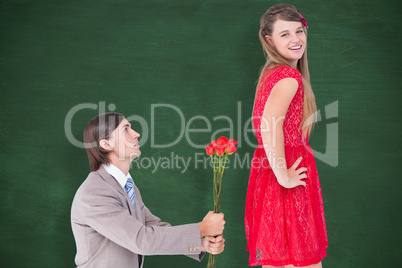 Composite image of hipster on bended knees behind his girlfriend