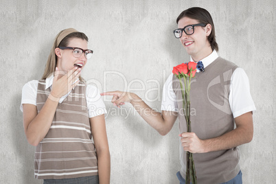 Composite image of geeky hipster offering red roses to his girlf