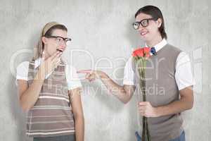 Composite image of geeky hipster offering red roses to his girlf