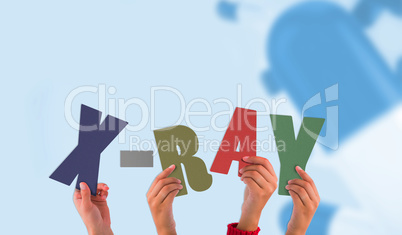 Composite image of hands holding up xray Composite image of hands holding up xray