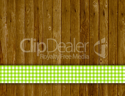 Holzbrett mit Holztextur und grünem Tischdeckenstreifen