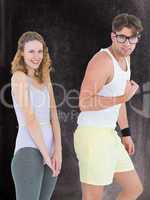 Composite image of geeky hipster couple posing in sportswear