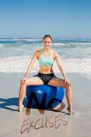 Composite image of fit woman sitting on exercise ball at the bea