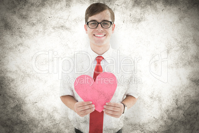 Composite image of geeky hipster holding heart card