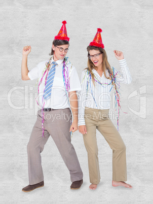 Composite image of happy geeky couple dancing