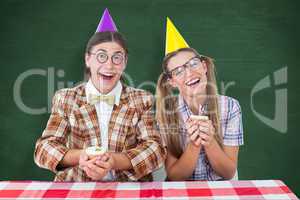 Composite image of geeky hipsters celebrating birthday