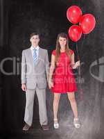 Composite image of unsmiling geeky couple standing hand in hand