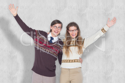 Composite image of happy geeky hipster couple embracing