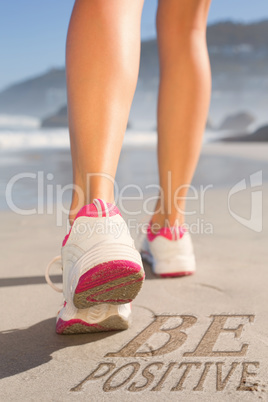 Composite image of fit woman walking on the beach