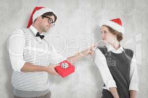 Composite image of geeky hipster offering present to his girlfri