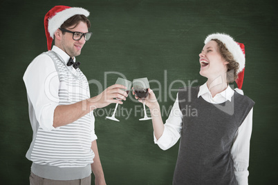 Composite image of happy geeky hipster couple drinking red wine