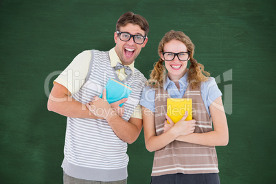 Composite image of geeky hipster couple holding books and smilin