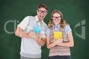 Composite image of geeky hipster couple holding books and smilin