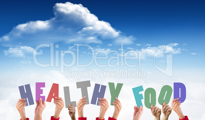 Composite image of hands holding up healthy foods