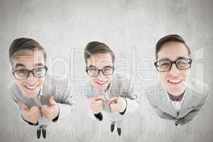 Composite image of nerdy businessman showing thumbs up