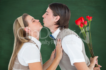 Composite image of geeky hipster holding roses and giving a kiss