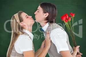 Composite image of geeky hipster holding roses and giving a kiss