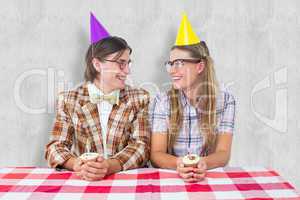 Composite image of geeky hipsters celebrating birthday