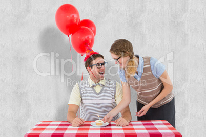 Composite image of geeky hipster couple celebrating his birthday