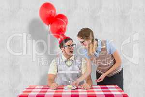 Composite image of geeky hipster couple celebrating his birthday