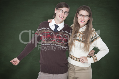 Composite image of happy geeky hipster couple embracing