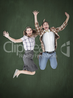 Composite image of geeky hipsters jumping and smiling