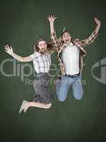 Composite image of geeky hipsters jumping and smiling