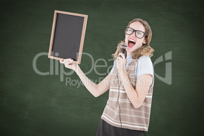 Composite image of geeky hipster woman holding blackboard and si