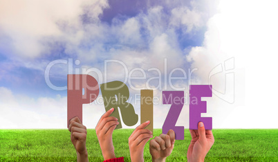Composite image of hands holding up prize