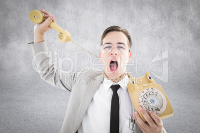 Composite image of geeky businessman being strangled by phone co