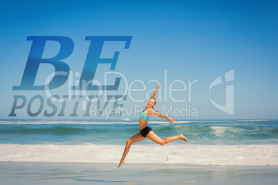 Composite image of fit woman jumping gracefully on the beach