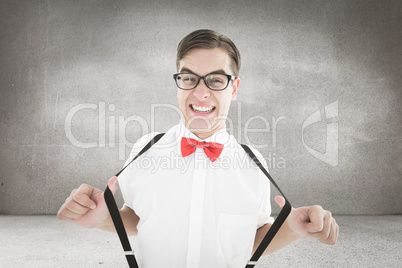 Composite image of geeky hipster pulling his suspenders