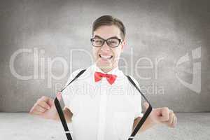 Composite image of geeky hipster pulling his suspenders