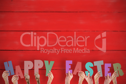 Composite image of hands holding up happy easter