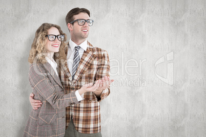 Composite image of geeky young hipster smiling at camera