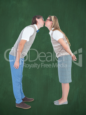 Composite image of geeky hipster couple kissing