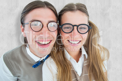 Composite image of geeky hipsters smiling at camera