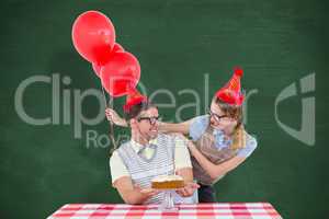 Composite image of geeky hipster couple celebrating his birthday