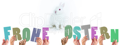 Composite image of hands holding up frohe ostern