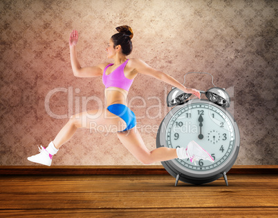 Composite image of fit brunette running and jumping