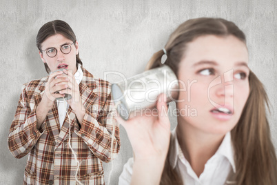 Composite image of geeky hipsters using string phone