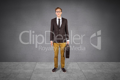 Composite image of young geeky businessman holding briefcase