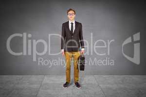 Composite image of young geeky businessman holding briefcase