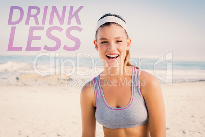 Composite image of sporty blonde on the beach smiling at camera