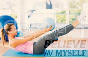Composite image of sporty young woman stretching body in fitness