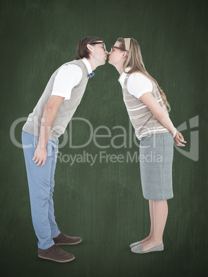 Composite image of geeky hipster couple kissing